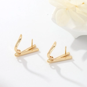 Close-up of golden leverback earring findings with loop for DIY jewelry making