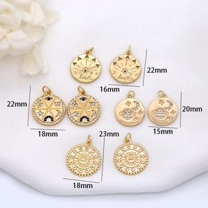 Detailed view of assorted gold-plated celestial pendants with zircon inlay and luck engraving