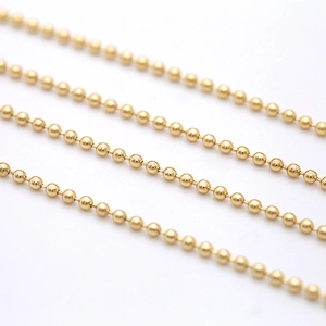 Macro shot of 2mm polished 14K gold-plated bead chain for DIY jewelry making
