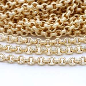 Detailed macro view of 14K gold-plated Rolo chain links with textured diamond-cut surface