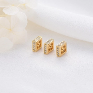 Detail of 14K gold plated square charm with micro-set zircon and star cutout