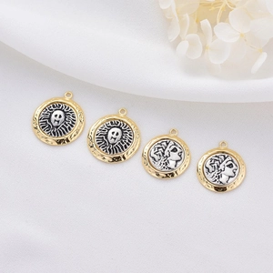 Detail of four 14K gold-plated umbrella pendants with vintage sun and profile relief