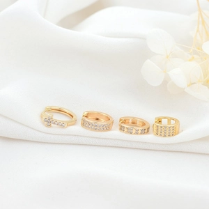 14K gold plated chunky hoop earrings set with zircon stones on white fabric