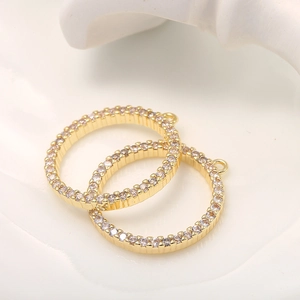 Macro shot of 14k gold circular jewelry connectors with micro-pave white zircon stones