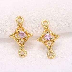 Close-up of gold plated rhombus jewelry connector with pink cubic zirconia for DIY making