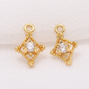 Detailed macro of 14k gold plated rhombus connector with sparkling cubic zirconia stone
