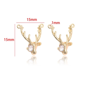 Detail view of 14k gold plated reindeer head charms with cubic zirconia measuring 15x15mm