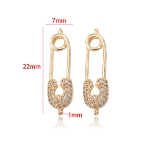 Detailed view of 14k gold-plated safety pin pendant with white zircons and dimensions
