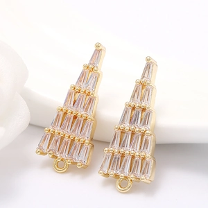 Macro detail of 14k gold plated Christmas tree pendant with cubic zirconia inlay