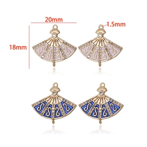 Detail of 20mm fan-shaped 14k gold plated pendants with zircon and enamel inlays