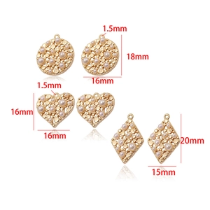 Detail view of 14k gold plated copper charm connectors with pearls for DIY jewelry making