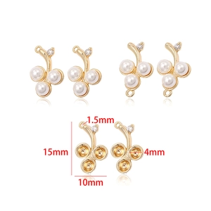 Detailed view of 14k gold-plated cherry pendant with pearls and zircon in two sizes