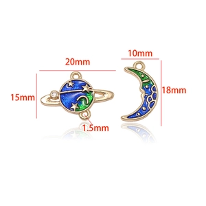 Detailed view of planet and moon alloy charms with blue gradient and gold star patterns