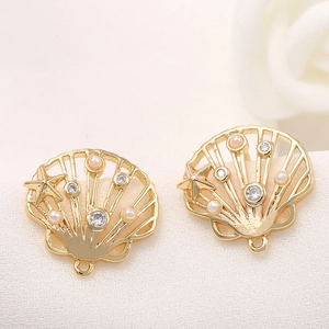 Macro view of gold shell pendant with pearl and zircon inlay for DIY jewelry making