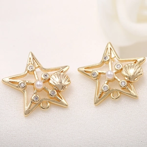 Close-up of gold star pendants with pearls and zircons for DIY jewelry making