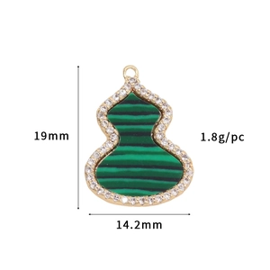Macro view of 14k gold-plated gourd pendant with green malachite and zircon pavé detail