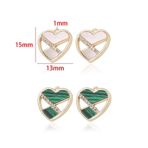 Macro detail of heart-shaped 14k gold-plated brass connectors with cubic zirconia inlay