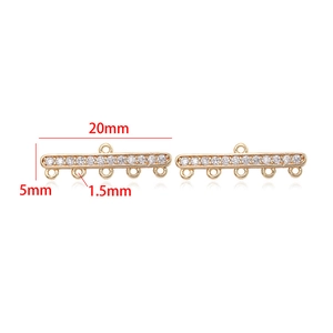 Detailed view of 20mm 14k gold plated bar connector with cubic zirconia and five loops