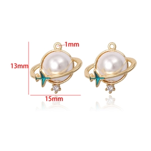 Detail of 14k gold plated Saturn pendant with pearl and cyan airplane charm