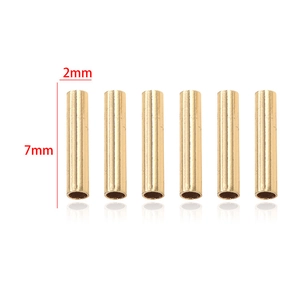 Close-up of 6 gold-plated 7x2mm cylindrical tube beads for DIY jewelry making