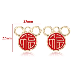 Detailed view of Fu character enamel gold pendant charm measuring 23mm by 22mm
