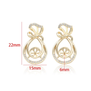 Detailed view of 14k gold-plated hollow teardrop earrings with zircon bow and 6mm pearl setting