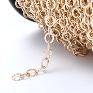 DIY gold copper oval link chain for jewelry making on a black spool holder