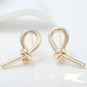 Close-up of 14k gold plated twisted knot charms with jump rings for DIY jewelry making