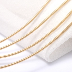 Macro view of 14k gold plated 1.6mm snake chain texture for DIY jewelry making