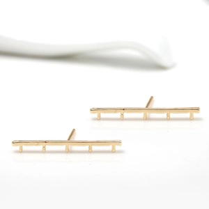 Detailed view of minimalist geometric 14k gold plated bar stud earrings with five vertical posts