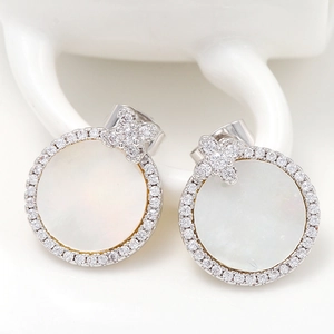 Detailed view of 925 silver bow stud earrings with white cat-eye stone and cubic zirconia