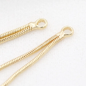 Detailed macro view of 14k gold plated snake chain tassel for DIY jewelry making