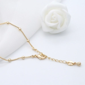 Elegant 14k gold beaded box chain with lobster clasp and teardrop pendant charm
