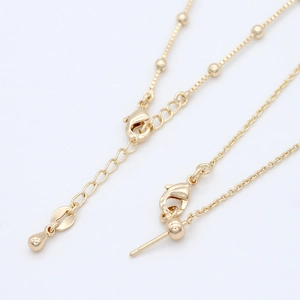 Detail of 14k gold plated ball chain with lobster clasp and adjustable drop extender