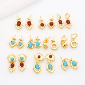Detailed view of gold sand-finish pendants with red and blue gemstones in various shapes
