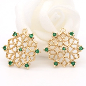 Macro d'un pendentif fleur en cuivre plaqué or 14 carats avec cristaux de zircon vert