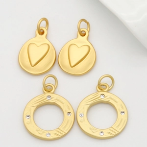 Matte gold jewelry pendants set with heart relief and crystal-encrusted rings