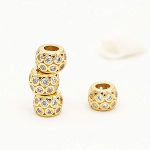 Detail of 14K gold plated hollow cylindrical beads with cubic zirconia for jewelry DIY