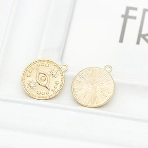 Détails macro de breloques dorées avec œil protecteur et étoiles pour bijoux DIY