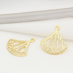 Detailed macro view of 14K gold plated fan shaped charm for DIY jewelry making accessories