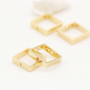 Macro shot of 14K gold plated square spacer beads with holes for DIY jewelry making