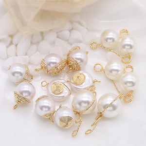 Macro shot of handmade 14k gold-wrapped pearl pendants for DIY jewelry crafting designs