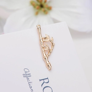 Elegant 14k gold-plated copper bamboo pendant with realistic leaves on white background