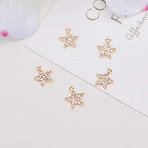 Macro detail of five pointed star pendants with 14k gold plating and sparkling cubic zirconia