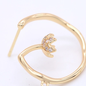 Detailed close-up of 14K gold circle earrings featuring a floral zircon cluster design