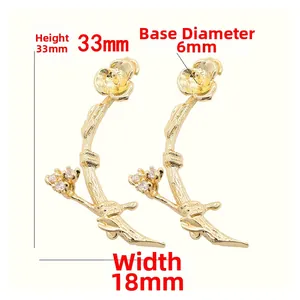 Detailed view of 14k gold plated branch earring charms with zircon accents, 33x18mm size