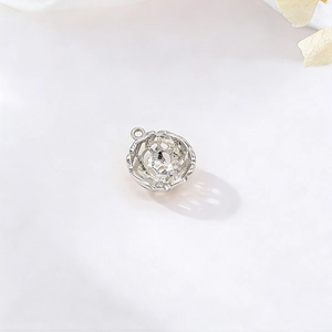 Hollow spherical woven silver pendant for DIY jewelry making on white background