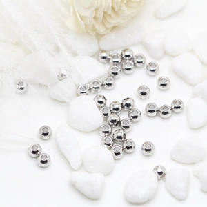 Polished 14K gold-plated spacer beads for DIY jewelry making on a white background