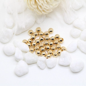Macro shot of 14K gold-plated copper spacer beads for DIY jewelry making and crafts