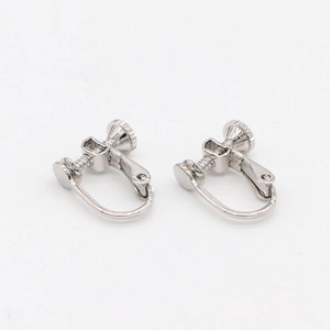 Macro view of polished silver screw earring converters for non-pierced jewelry